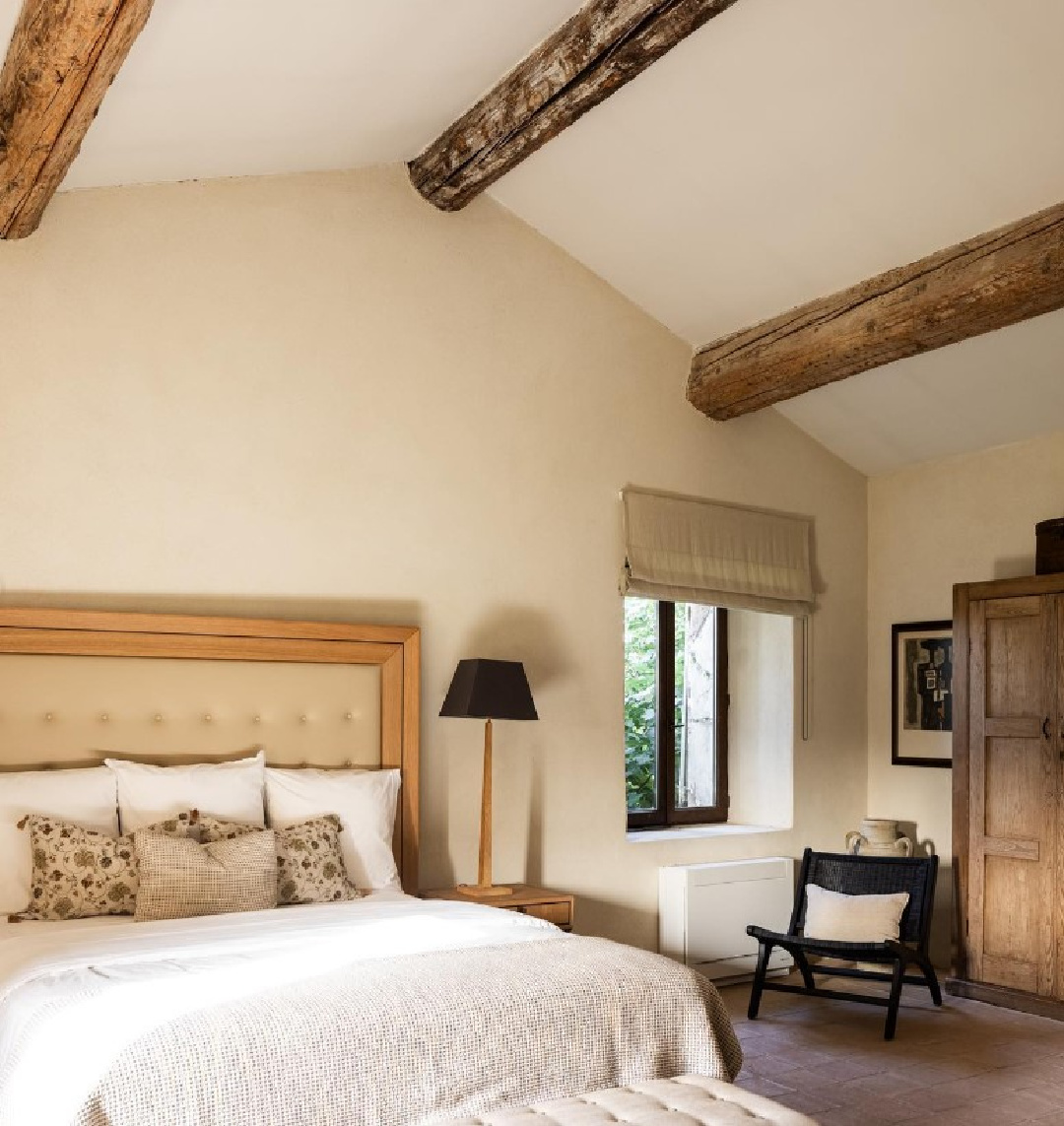 French country rustic bedroom with wood beams. Warm European luxury and cozy opulence in a French vacation villa in Provence - La Bastide de Laurence. #frenchbastide #frenchvilla #luxuryvilla #provencevilla #warmeuropeanluxury #cozyopulence #provencehomes #frenchcountryinterior