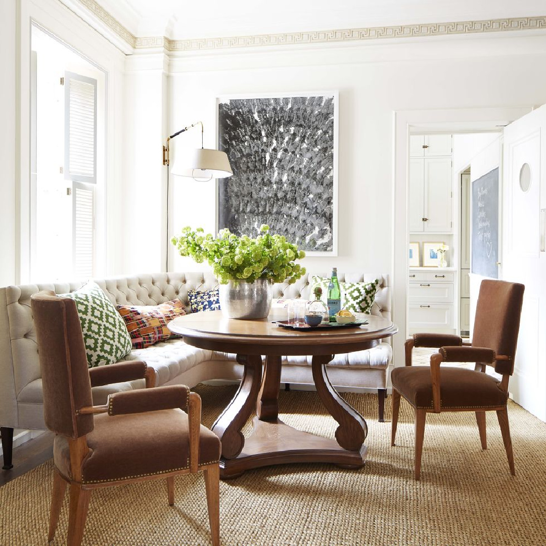Tufted banquette seating around brown round dining table on woven rug - Peter Dunham (photo: Max Kim-Bee) in Veranda.