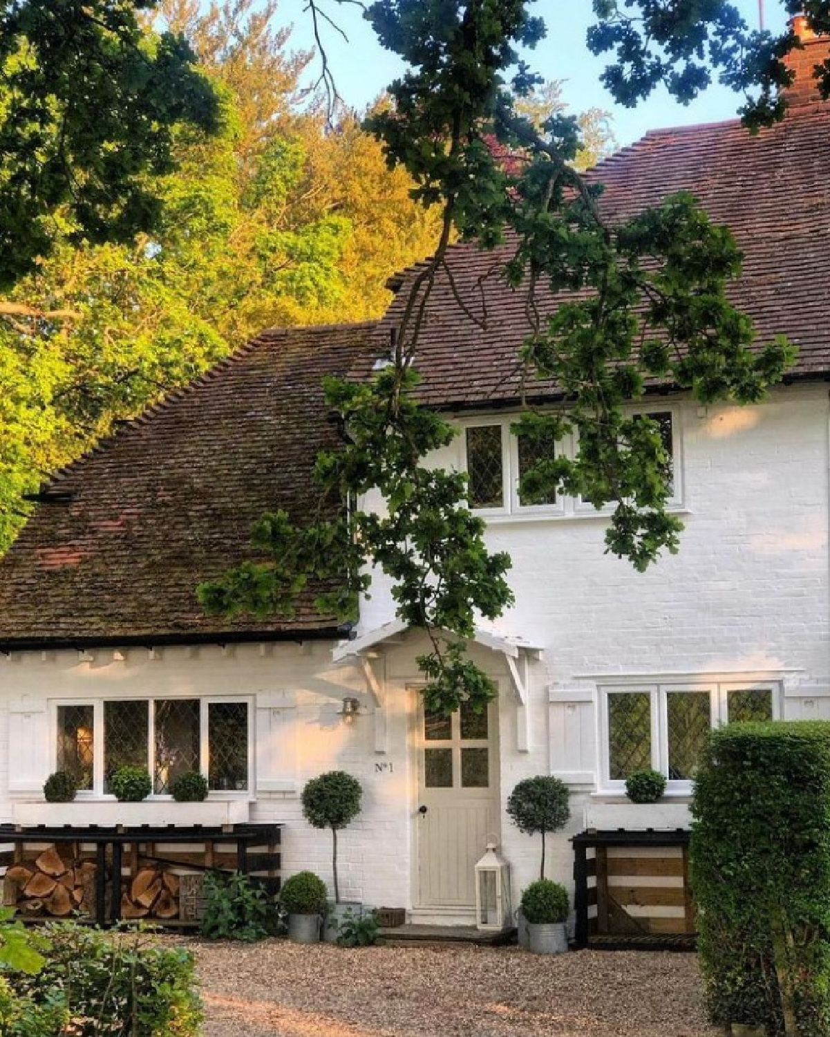 Lovely English country white cottage with topiaries at door and timeless design - @vintage.white. #facadelovers #englishcountrycottage