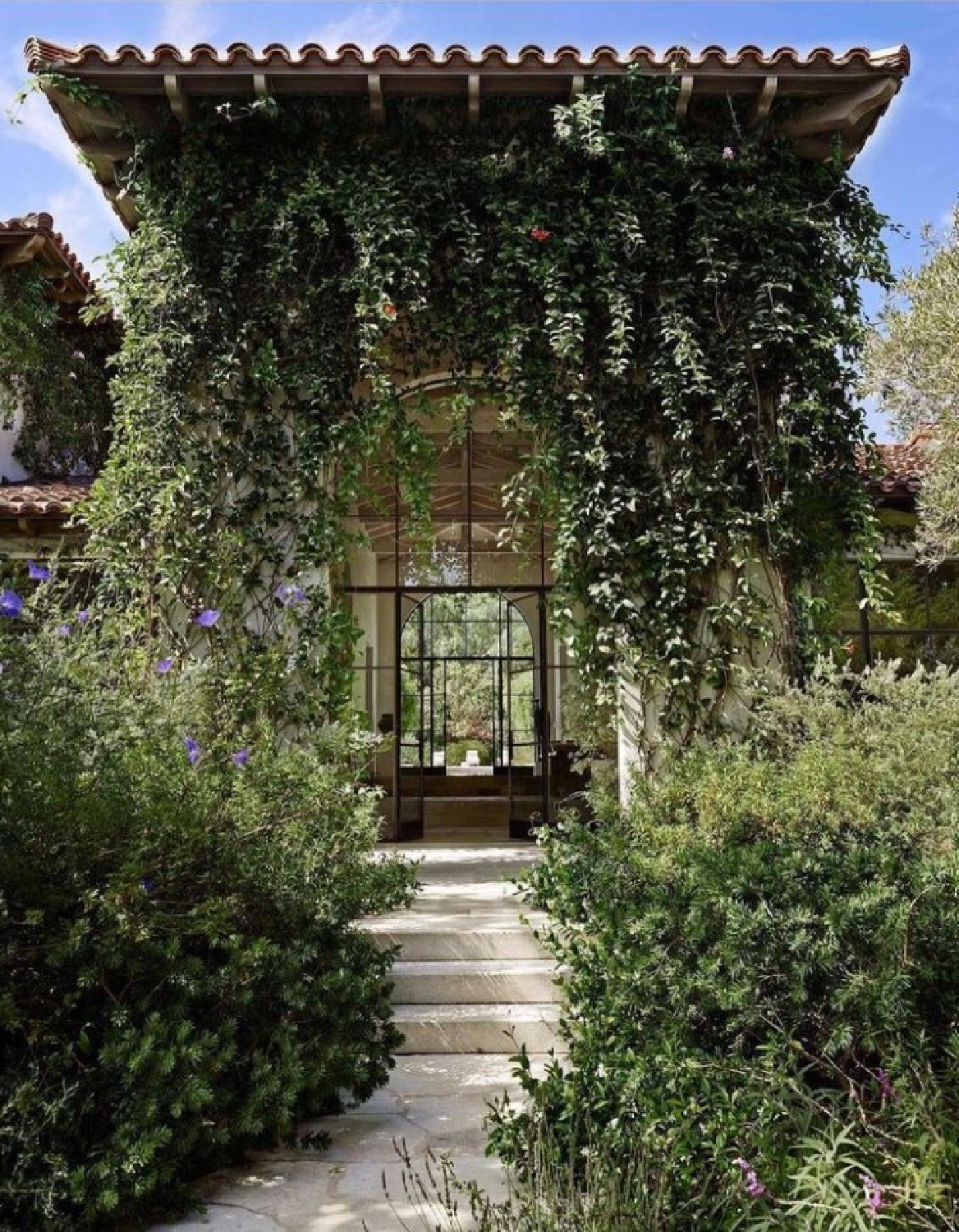 Lush green garden, stone steps, and a Mediterranean timeless home - @worldarchitectureinterior.