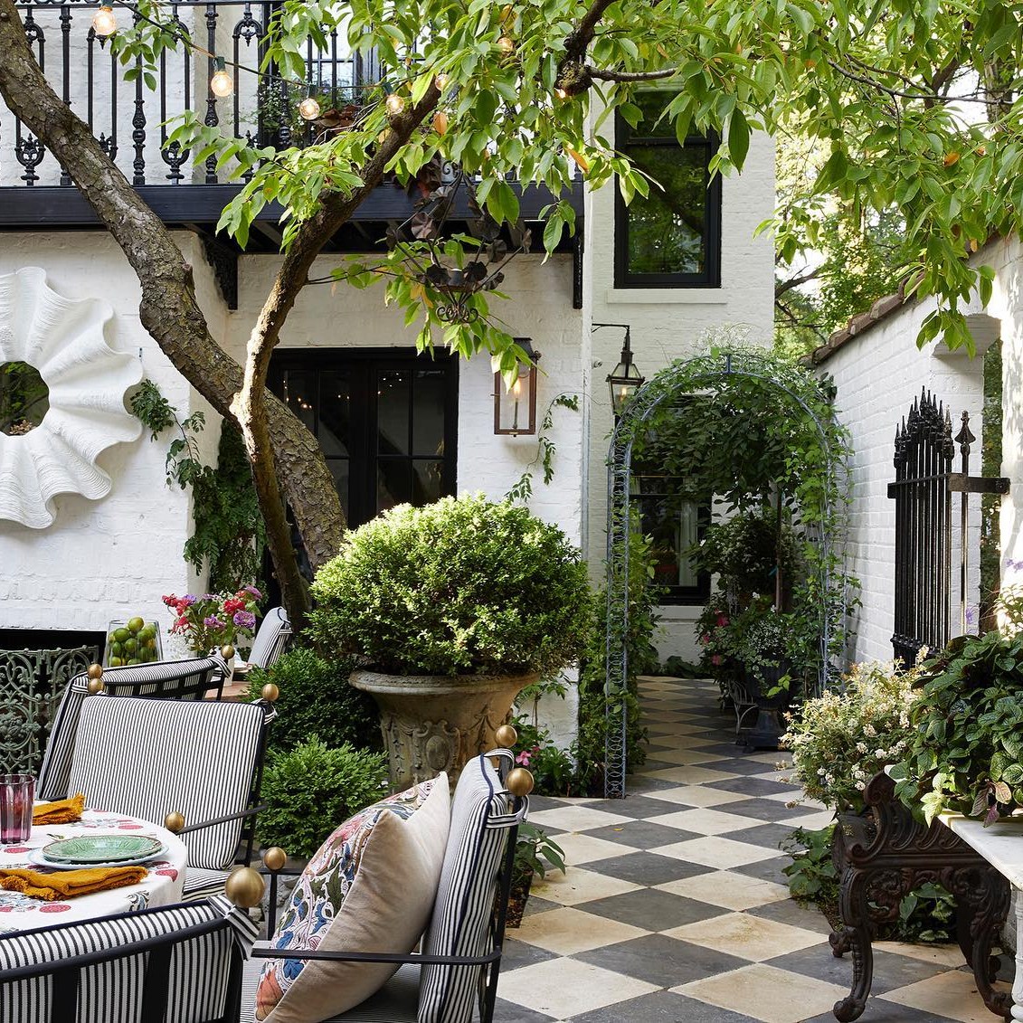 Summer Thornton's own home and patio with whimsical checkered beautiful stone patio.