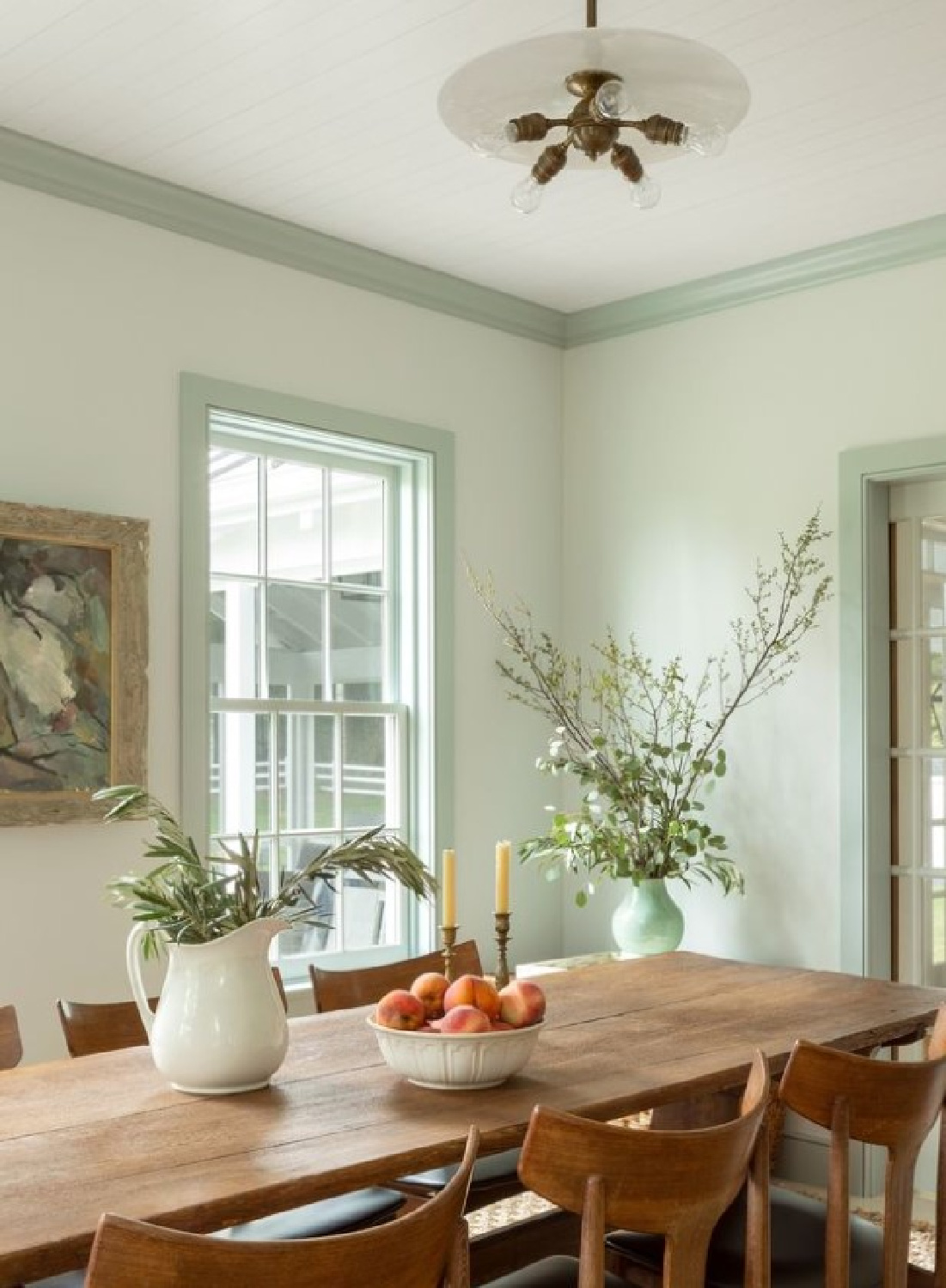 Beautiful country dining room with celadon trim in a home by Joshua Smith. #celadonpaintcolor #greeninteriors #greentrim