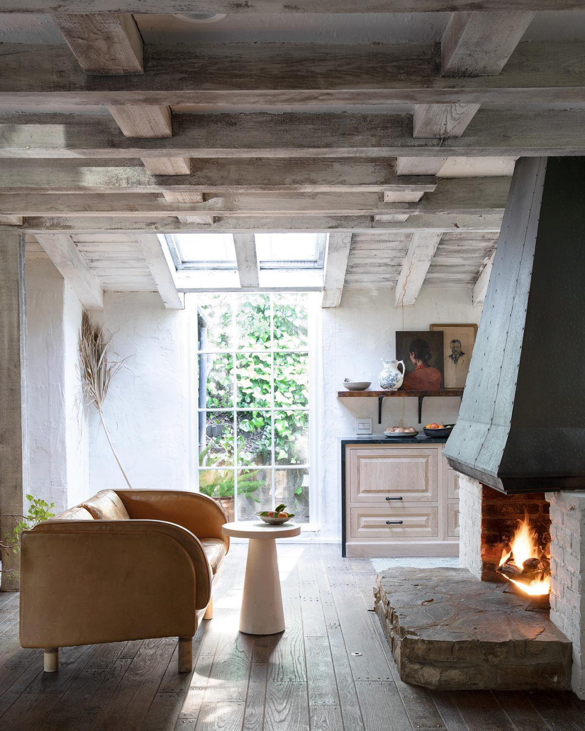 Leanne Ford designed cozy rustic modern minimal interior with fireplace and wood ceiling. #leanneford #cozymodernrustic #cozyinteriors