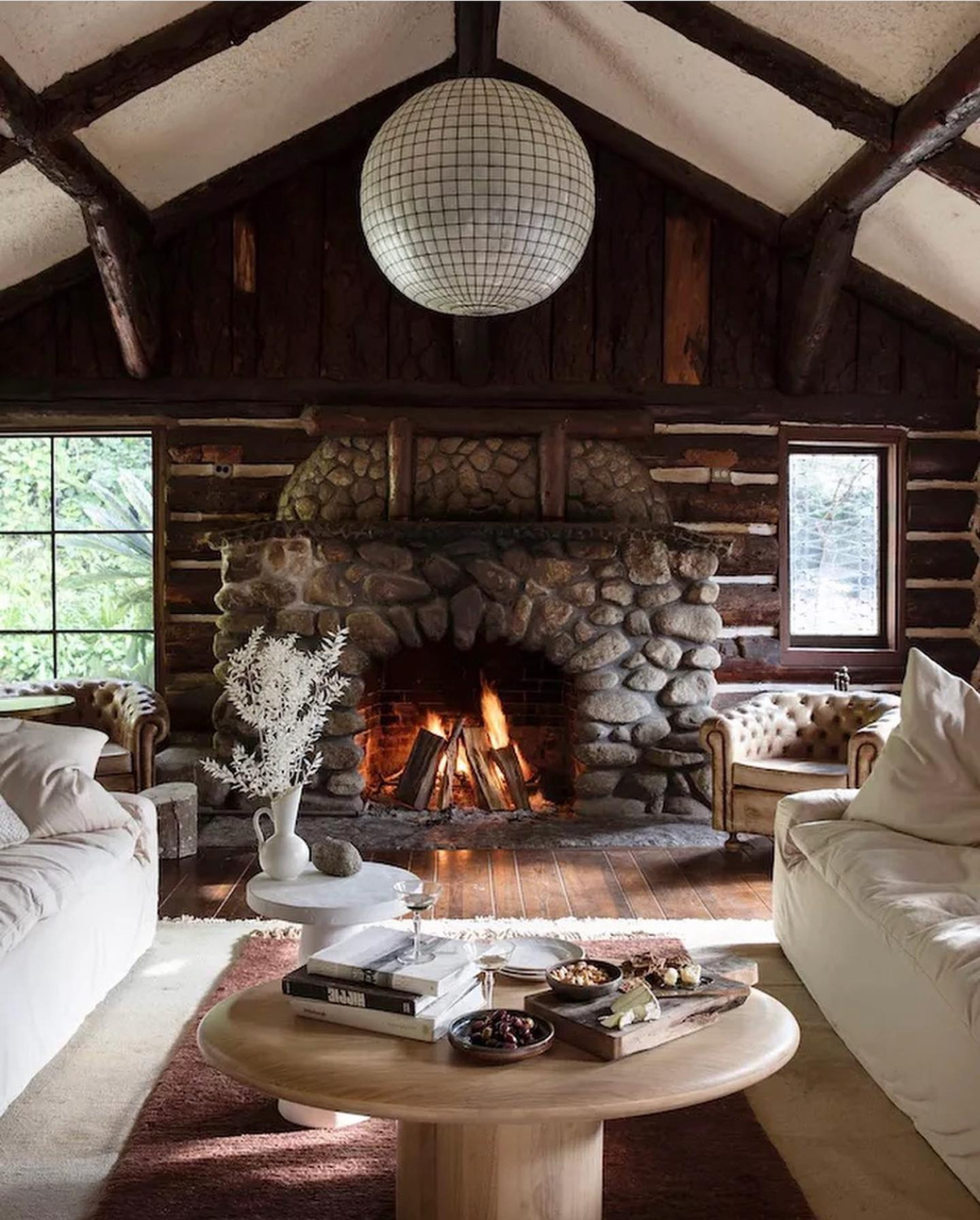 Leanne Ford designed cozy rustic cabin space with stone fireplace. #leanneford #rusticluxe #cabinvibes