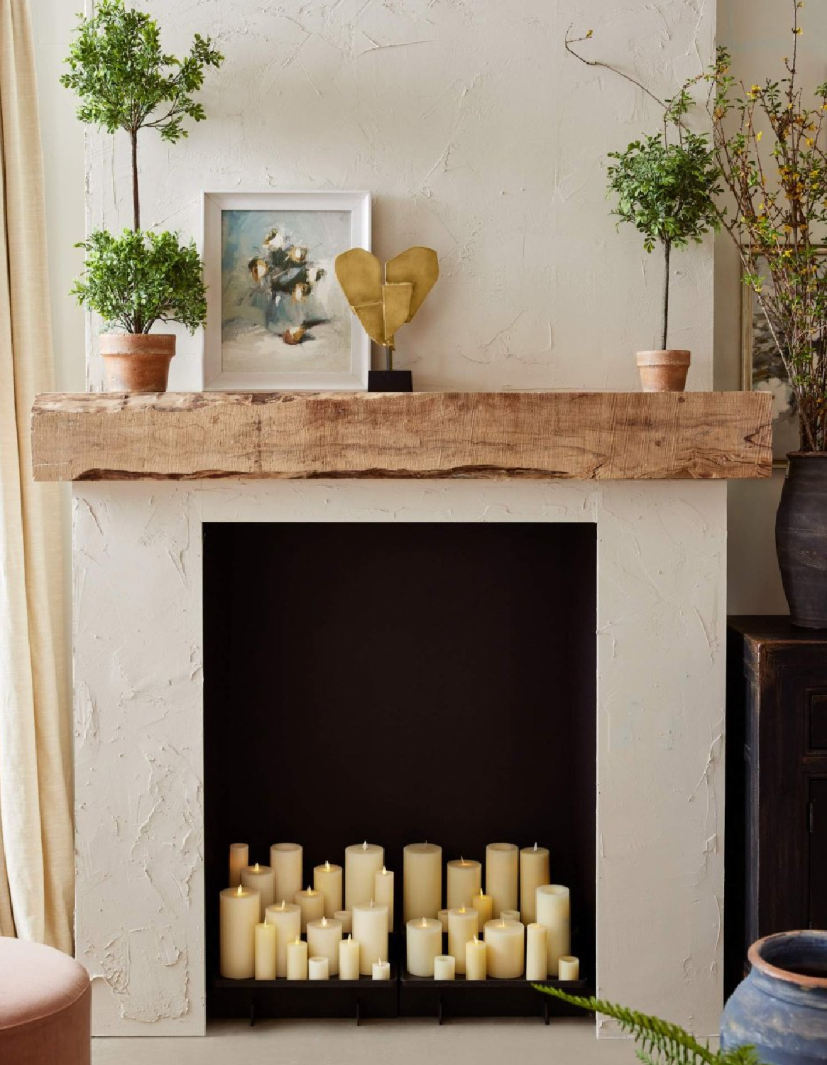 Fireplace with candles and rustic mantel, Pottery Barn.