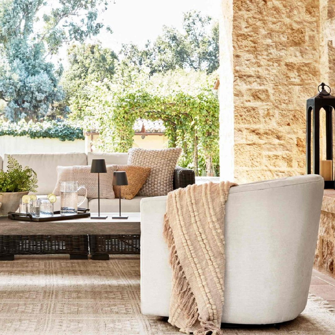 Outdoor furniture and swivel chair on beautiful loggia with stone, Pottery Barn.