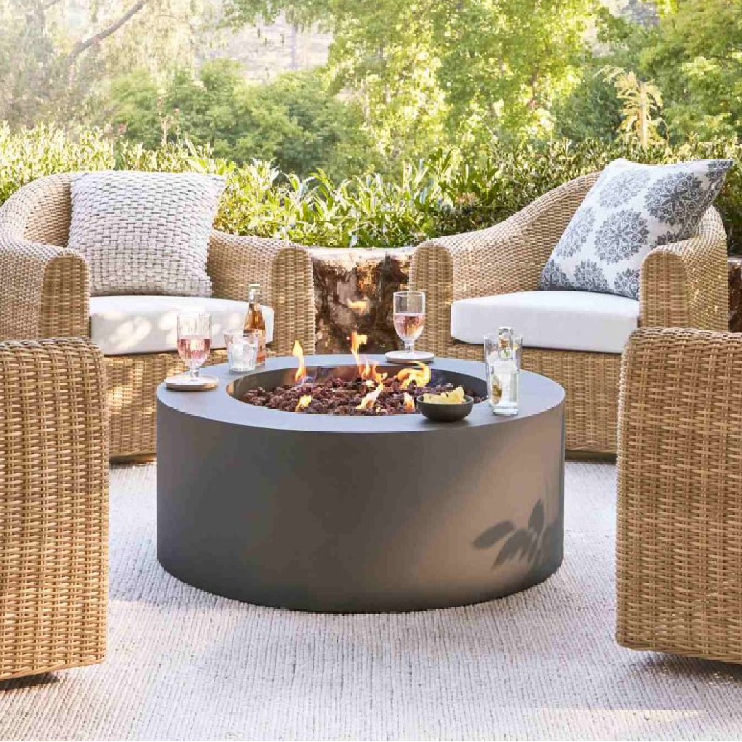 Conversational area on patio with firepit and swivel chairs, Pottery Barn.