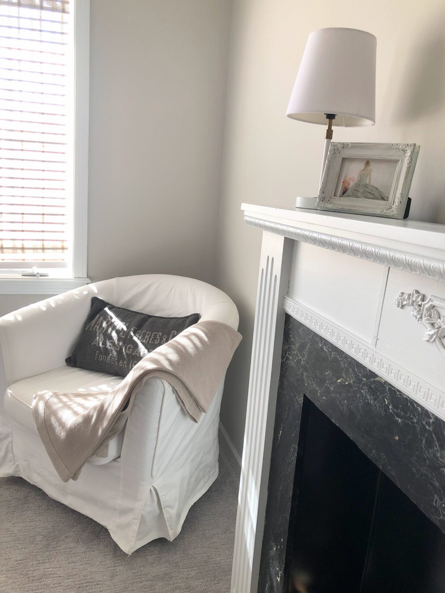 Holly Irwin art in serene bedroom with Belgian style, fireplace and SW Agreeable Gray Walls - Hello Lovely. #agreeablegray