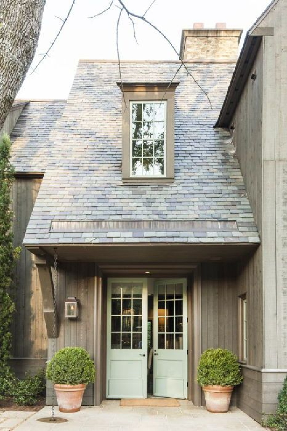Bevolo Williamsburg lantern fixture on a beautiful home with steep roof and dormer. #housefacades