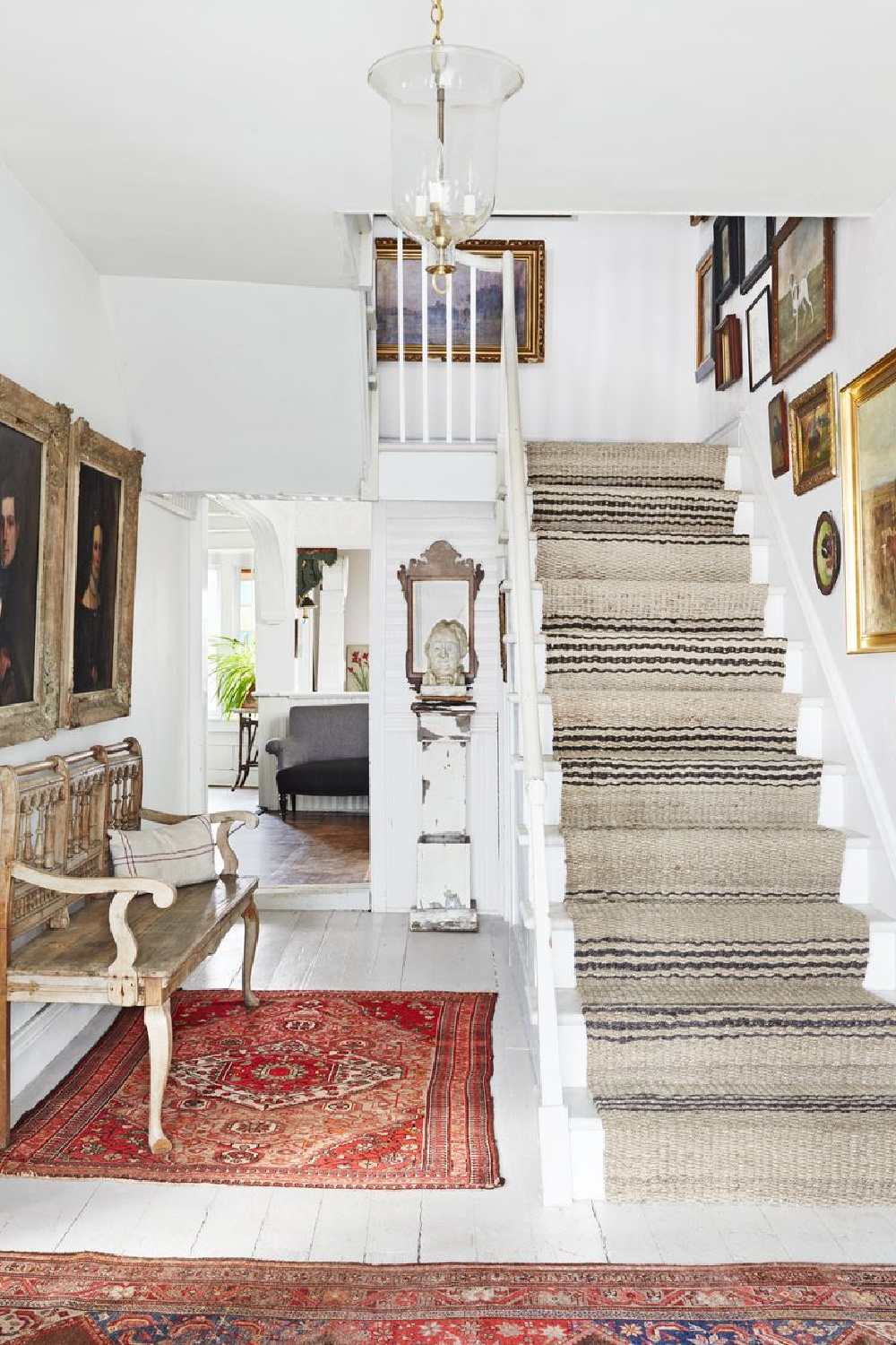 Country house staircase with gallery wall and stripe jute runner in country Living (David A. Land). #staircasedesign