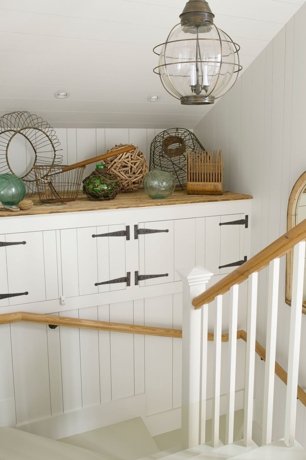 Storage in a staircase landing within a country house - Country Living (Gridley Graves). #staircasedesign