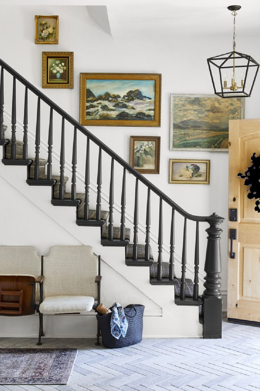 Lovely art decorating a black painted staircase in a country home - Country Living (Kim Cornelison). #countrystaircase