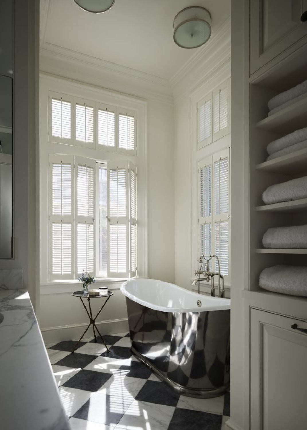 Checkerboard floors and soaking tub in a luxurious bath by Fisher Weisman in San Francisco. #checkeredfloors