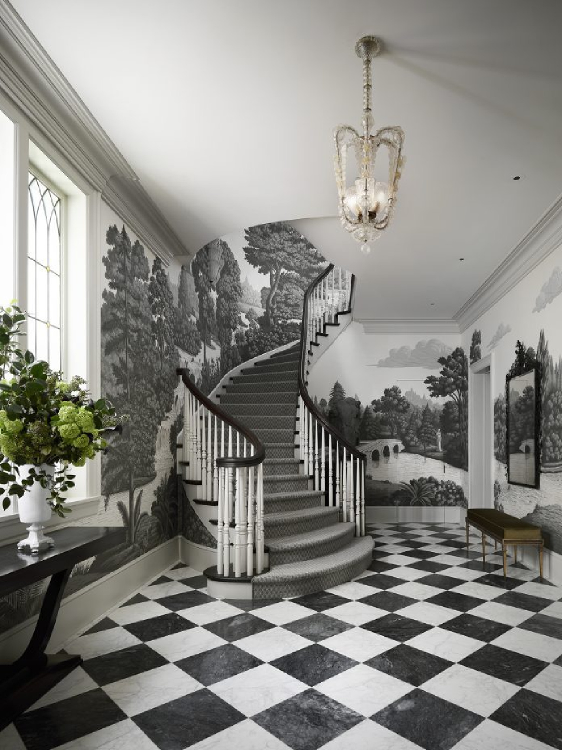 Stunning entry with grisaille landscape DeGournay wallpaper, black and white checkered floors, and design by Fisher Weisman. #grisaillewallpaper #degournaywallpaper #muralwallpaper #checkeredfloors