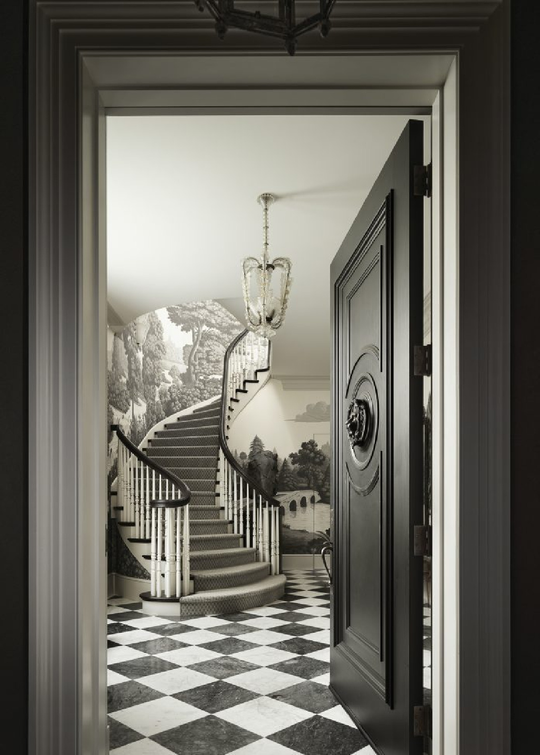Black door, checkered marble tile, and stunning staircase with grisaille landscape DeGournay wallpaper - Fisher Weisman. #blackdoors