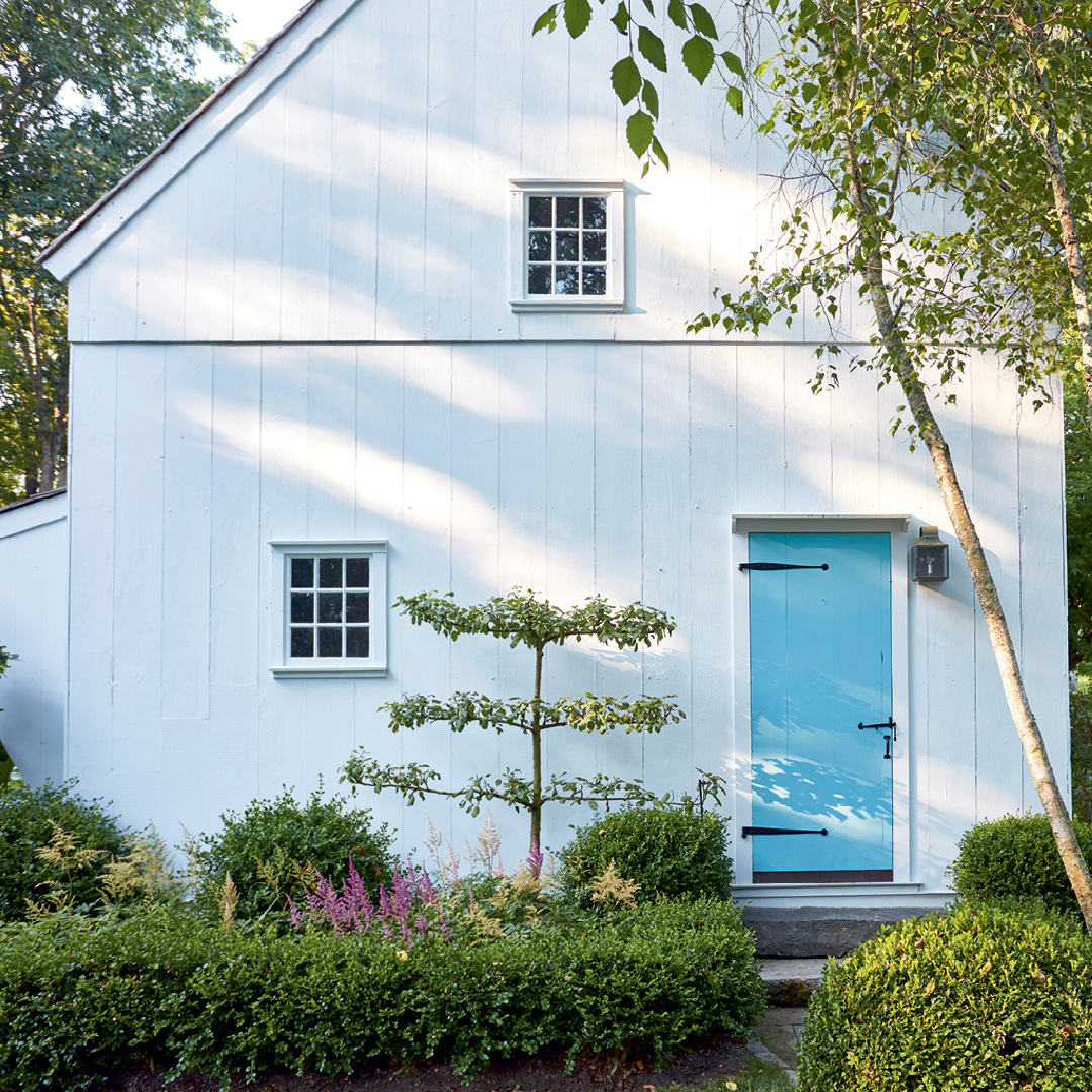 White barn with turquoise blue door in Nora Murphy COUNTRY HOUSE LIVING. #newenglandstyle #americancountry #americanfarmhouse