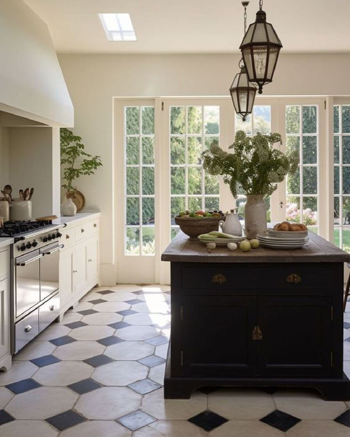 Classic traditional kitchen with lantern pendants over work island.