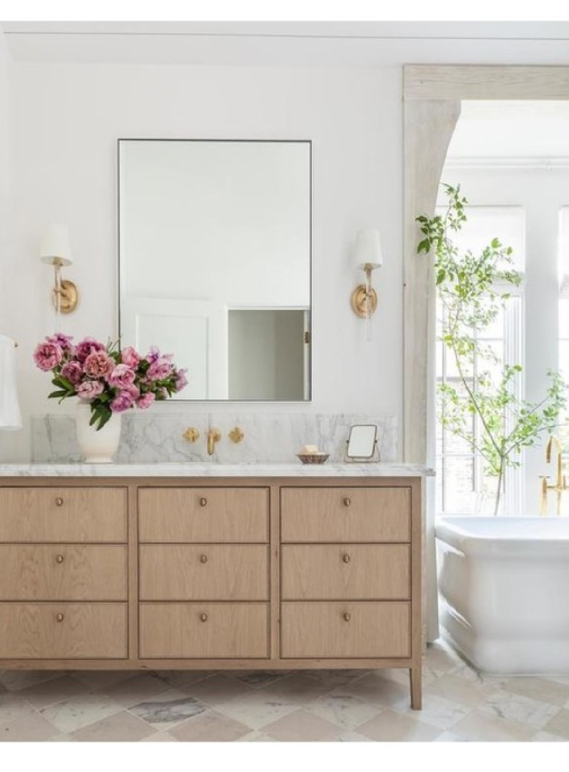 Marie Flanigan designed sconces (Abigail) for Visual Comfort in a lovely timeless bath.