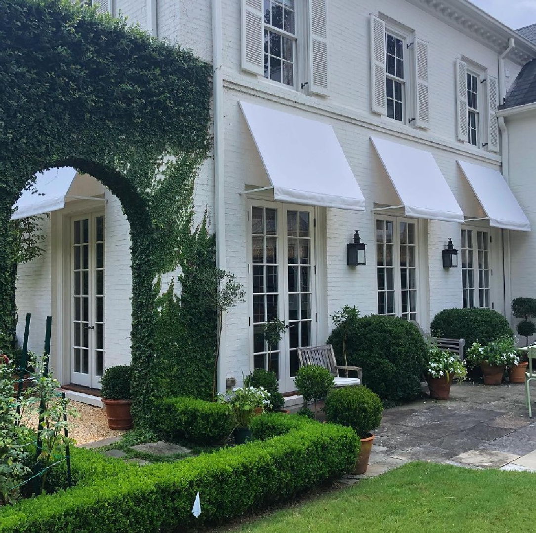 Beautiful traditional white Southern home with awnings (Caroline Gidiere Design and architect James Carter). #carolinegidiere #whitefacades