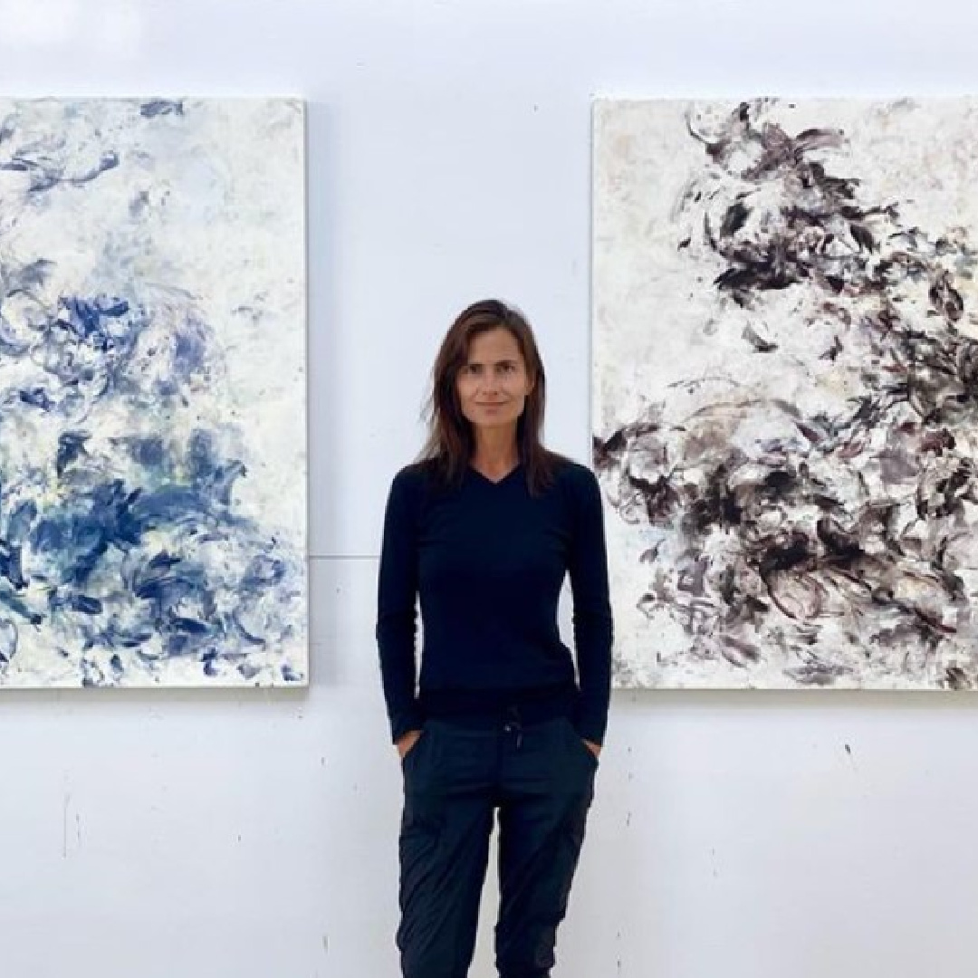 Fine artist Betsy Eby with two of her encaustic paintings.