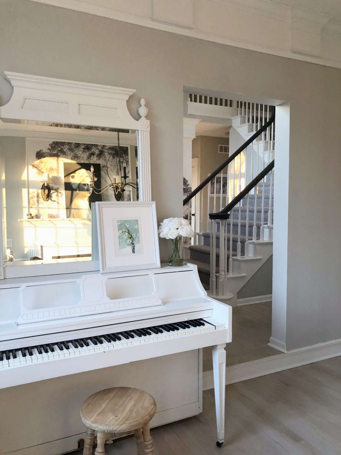 Serene music room with white piano, Holly Irwin painting, and SW Repose Gray walls - Hello Lovely. #reposegray #hollyirwin