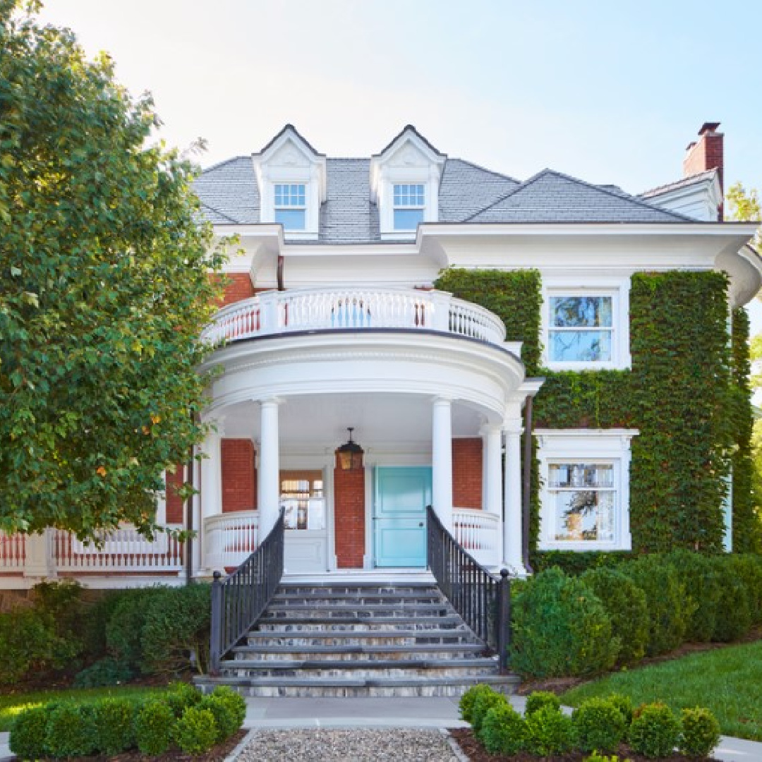 Miles Redd Victorian ivy covered home exterior with bright blue door (Benjamin Moore Skyscraper).