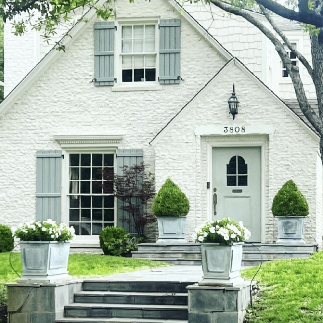 Lovely white house facade with shutters - The Potted Boxwood.