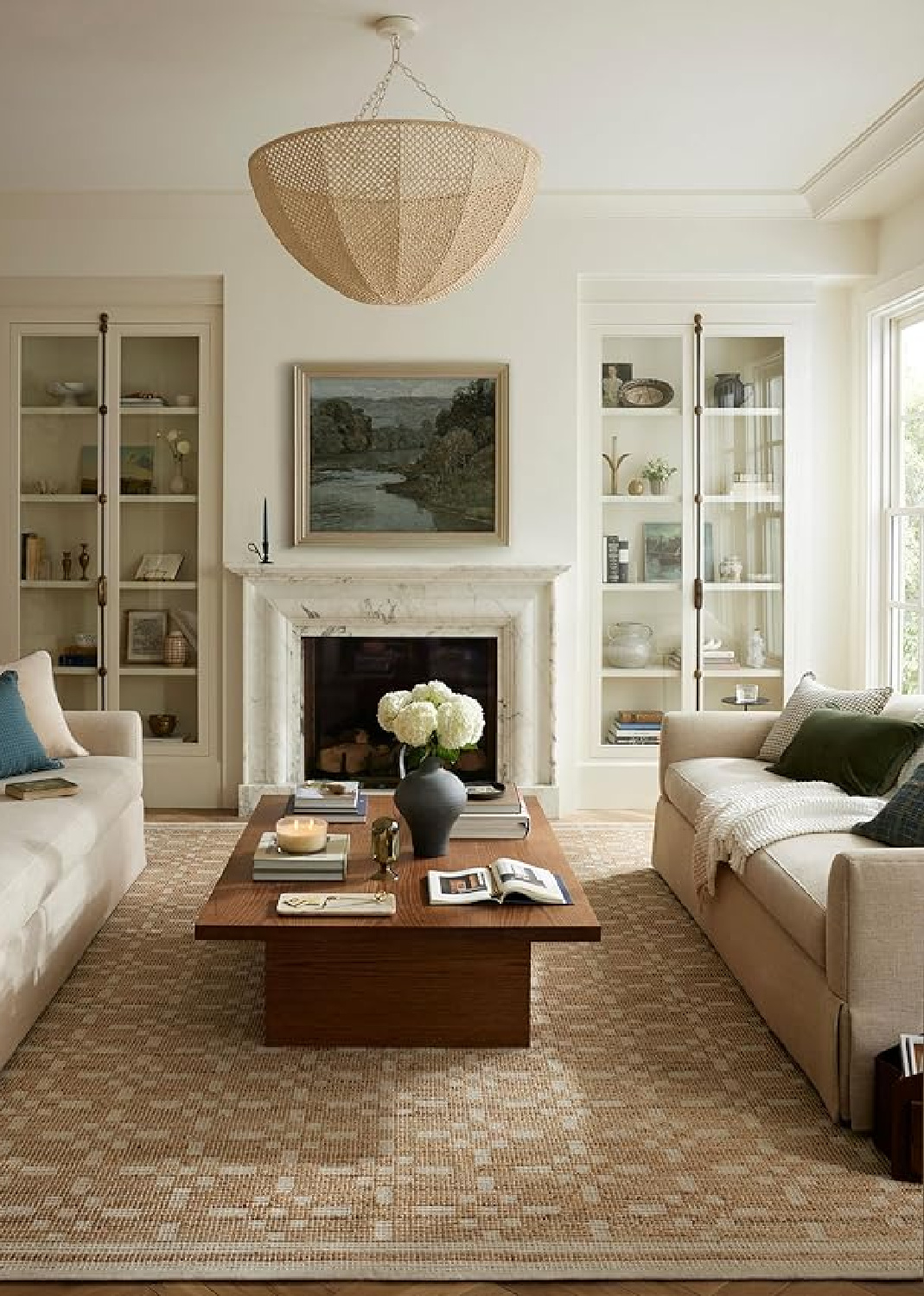 Timeless family room with marble fireplace and glass fronted builtins - Chris Loves Julia Judy Collection rug from Loloi. #cozyinteriors #timelessinteriors