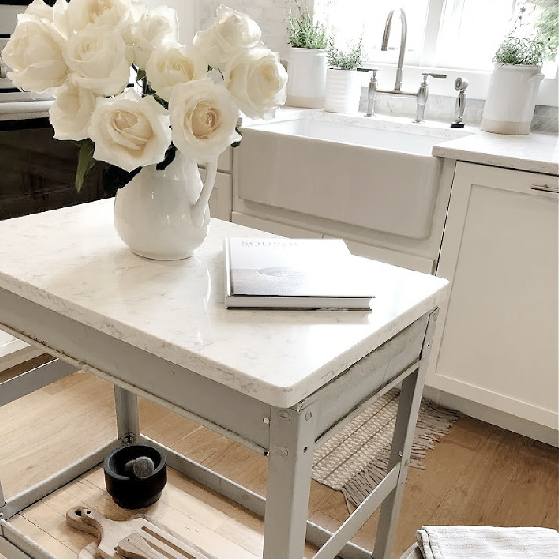 Minuet quartz topped industrial cart in my kitchen with white roses in pitcher - Hello Lovely Studio. #modernfrench #minuetquartz