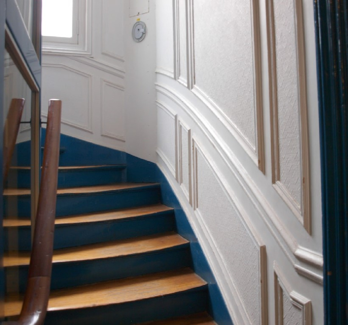 Stairway with paneled molding and royal blue trim in a Paris apartment building near Notre Dame - Hello Lovely Studio.