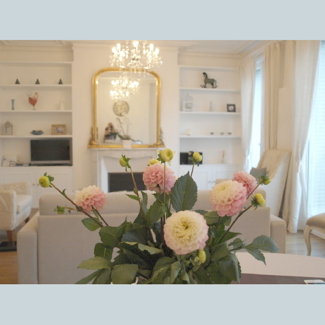 Beautiful ranunculus arrangement on dining table in an elegant and serene Paris apartment near Notre Dame - Hello Lovely Studio.