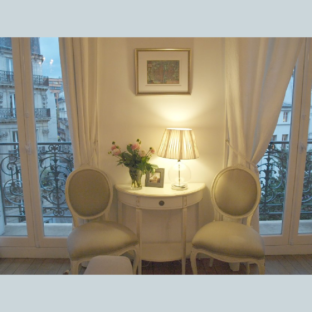Ambient light in the living room with sets of French doors to balconies in a Paris apartment near Notre Dame - Hello Lovely Studio.