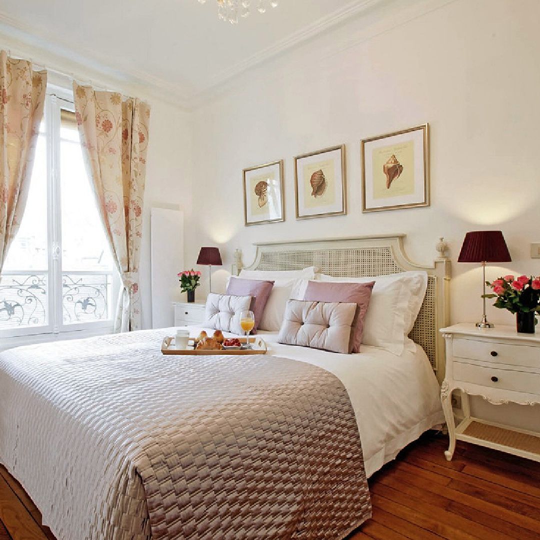 Paris apartment bedroom with hardwood floors, balcony and lavender accents - Hello Lovely Studio.