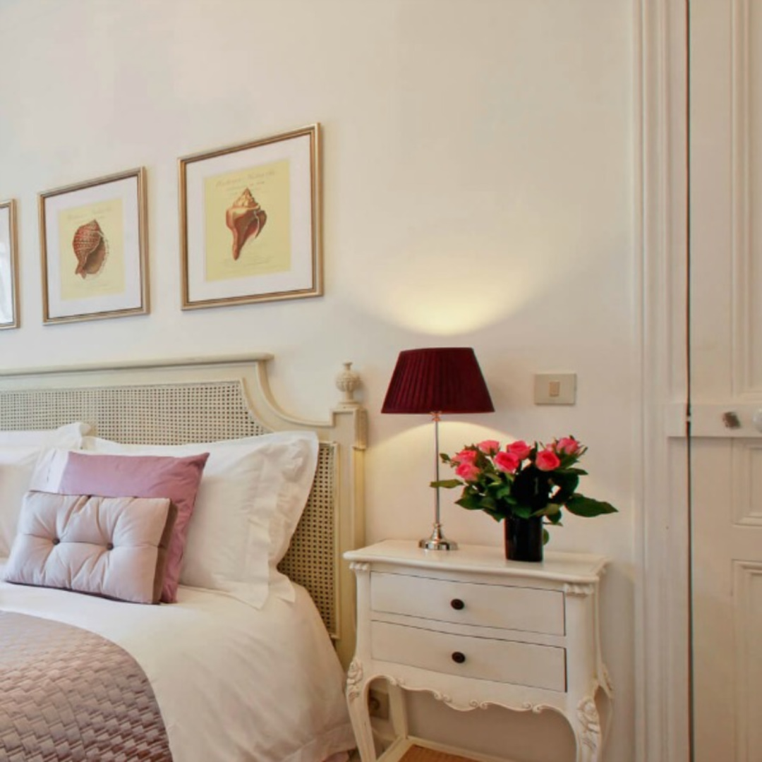 Paris apartment romantic bedroom decor with lavender accents and white walls - Hello Lovely Studio.