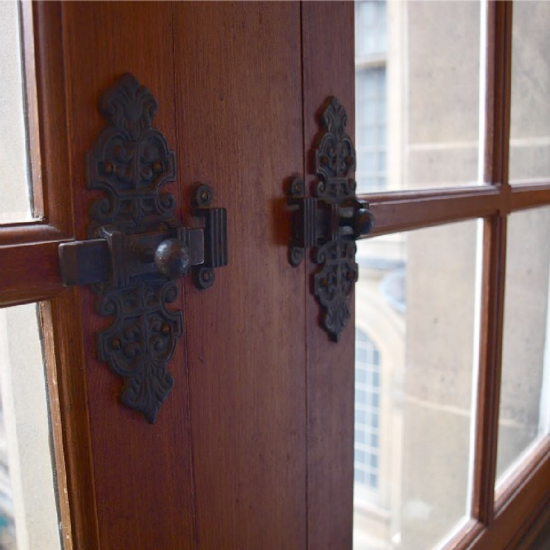 Beautiful antique hardware latches and windows at Hotel Carnavalet in Paris - Hello Lovely Studio. #hotelcarnavalet
