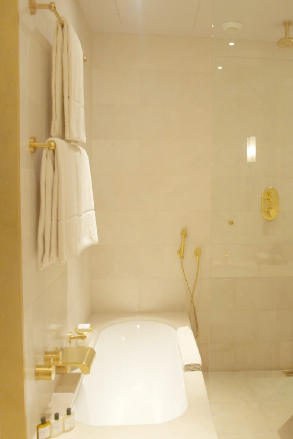 Creamy marble and gold hardware in a luxurious bathroom in our suite ata the Park Hyatt Paris Vendome - Hello Lovely Studio.
