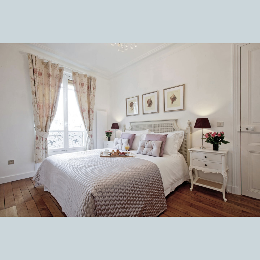 Charming bedroom with lavender accents and wood floors in a Paris apartment near Notre Dame - Hello Lovely Studio. #parisapartment