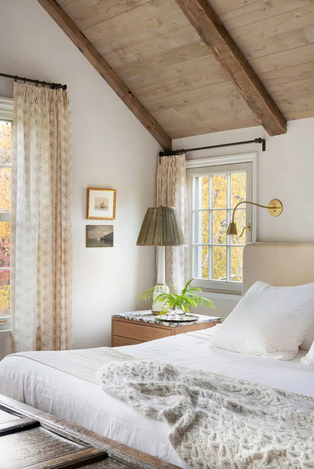 Rehkamp Larson Architects designed cozy European country cottage bedroom with wood ceiling and calm color palette. #europeancottage #cozybedrooms #timelessinteriors