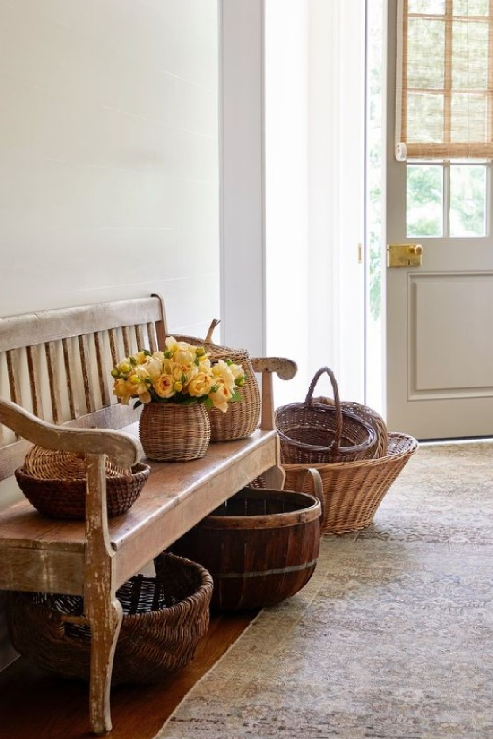 Baskets in a serene entry area with bench. Timeless interior design by Shannon Bowers with nods to European antiques, patina, understated elegance, and sophisticated simplicity. #shannonbowers #timelessinteriors