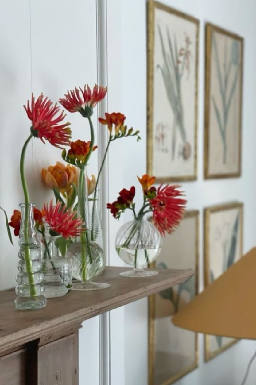 Cheerful flowers on a mantel. Timeless interior design by Shannon Bowers with nods to European antiques, patina, understated elegance, and sophisticated simplicity. #shannonbowers #timelessinteriors