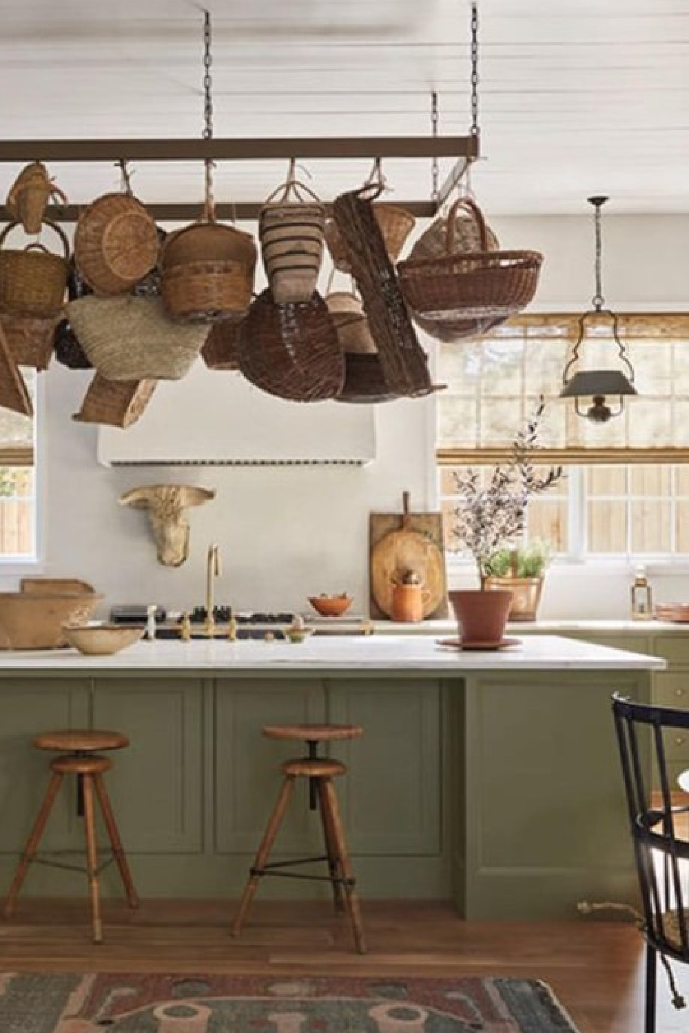 Basket collection over showhouse kitchen island. Timeless interior design by Shannon Bowers with nods to European antiques, patina, understated elegance, and sophisticated simplicity. #shannonbowers #timelessinteriors