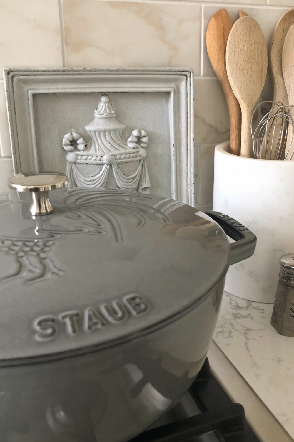 Detail of beautiful reflective coating on Staub French Oven with Rooster (Graphite Grey) in my modern French kitchen with Muse quartz - Hello Lovely Studio. #staub #frenchkitchens #dutchovens