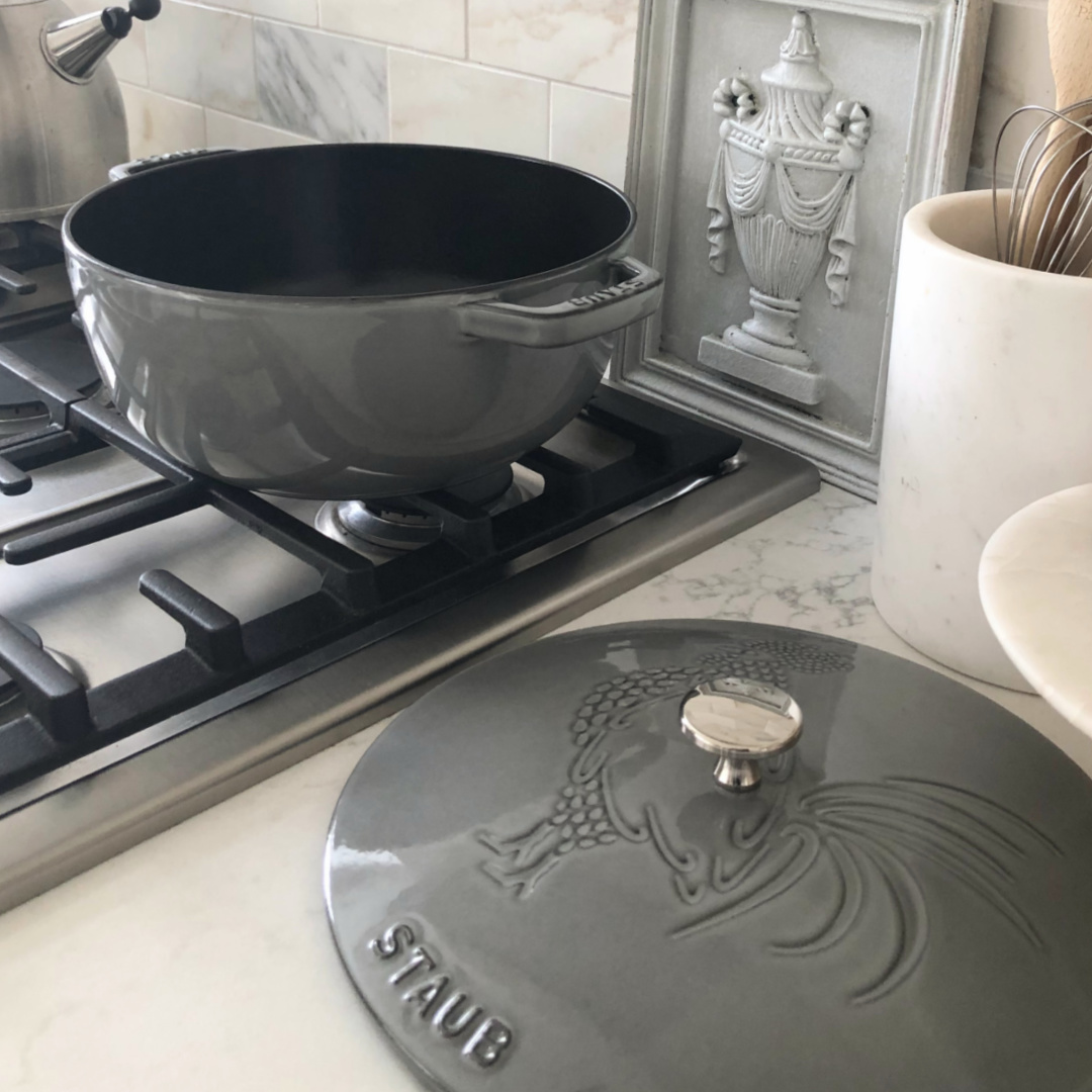 Staub French oven with rooster (Graphite Grey) in my modern French kitchen with Muse quartz and marble subway backsplash - Hello Lovely Studio. #modernfrench #staub #dutchovens