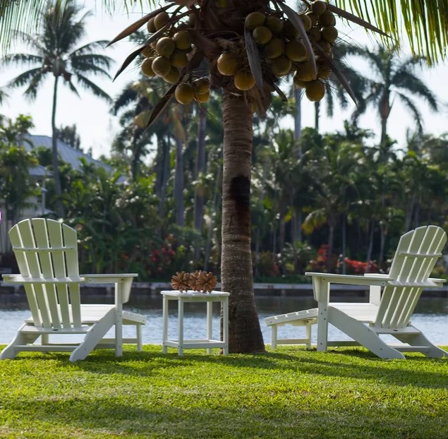 Two white adirondack chairs with hideaway chaise at water's edge - Wayfair. #adirondackchairs #adirondackchaise