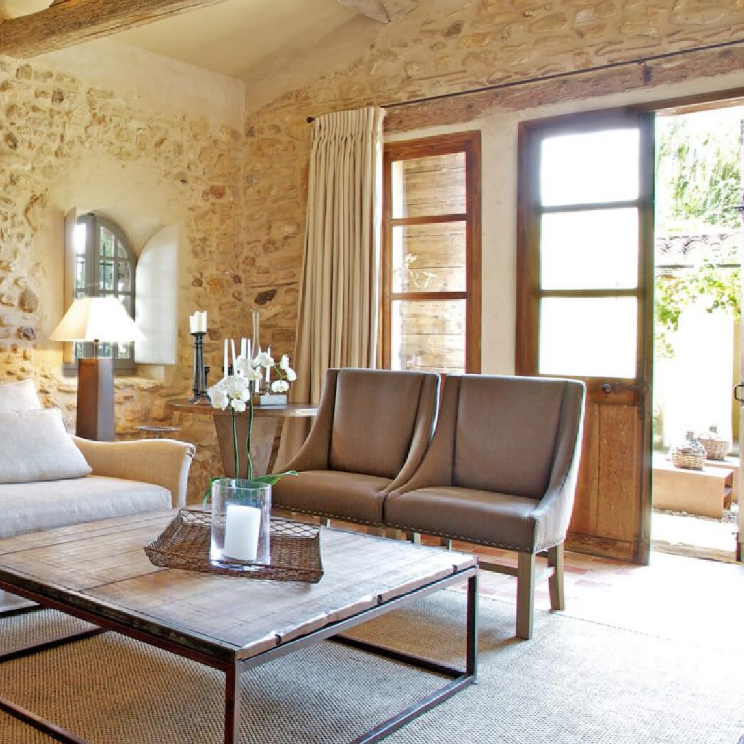 Old World style living room with stone walls, arched windows, shutters, and charming French country charm - Bonnieux villa in Provence (Your Haven in Paris).