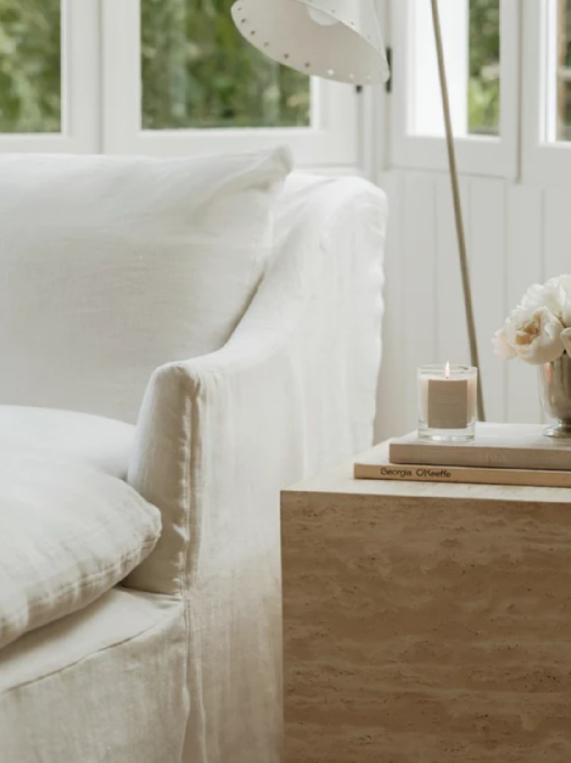 Belgian linen chaise and Oak Essentials candle - Jenni Kayne Home.