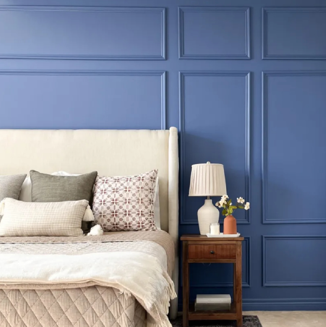 Benjamin Moore Blue Nova 825 on a bedroom wall with applied trim and wingback bed - Hana's Happy Home. #benjaminmoorebluenova #bluepaintcolors