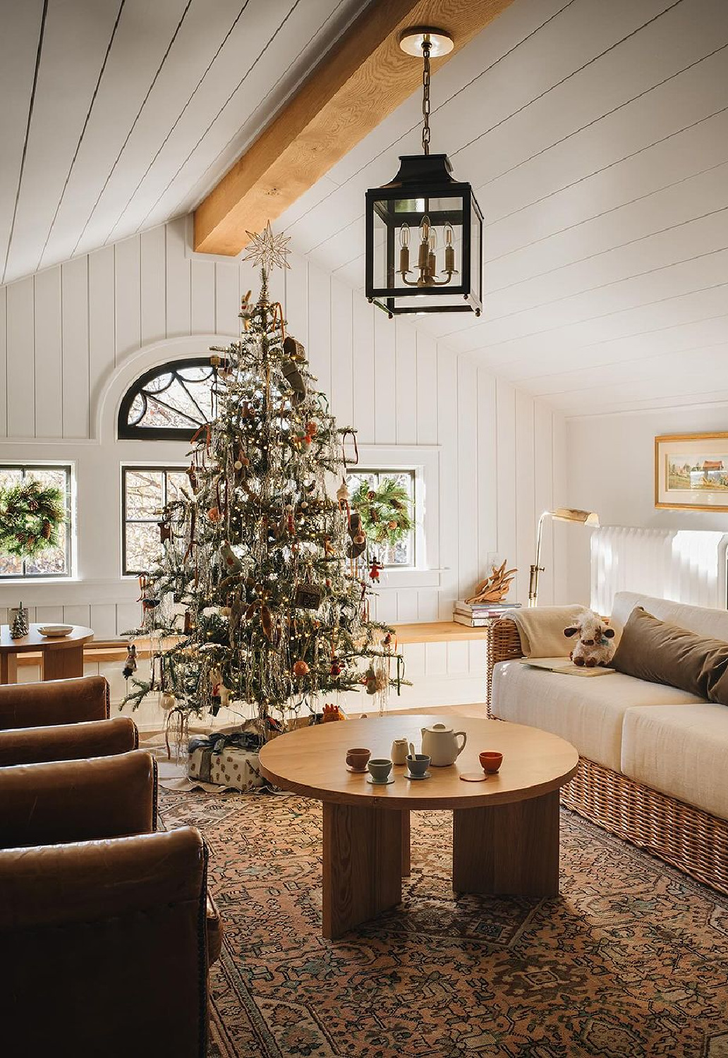 Freshened traditional interior with holiday decor and Christmas tree with tinsel - @jeanstofferdesign.