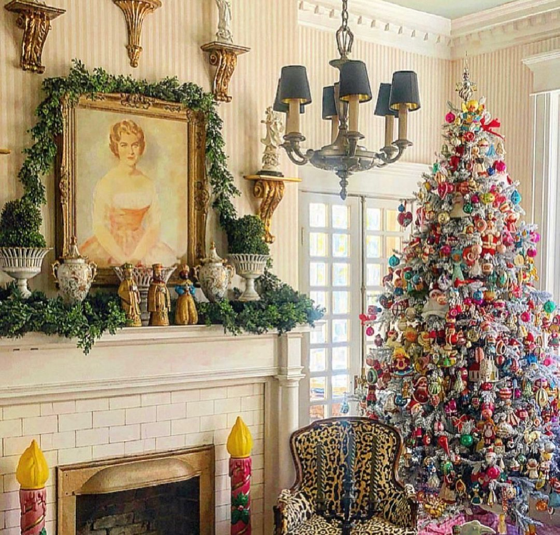 Colorful Old fashioned Christmas tree in traditional interior with fireplace and garland - @parkerkennedyliving. #oldfashionedchristmas #christmastreedecorations
