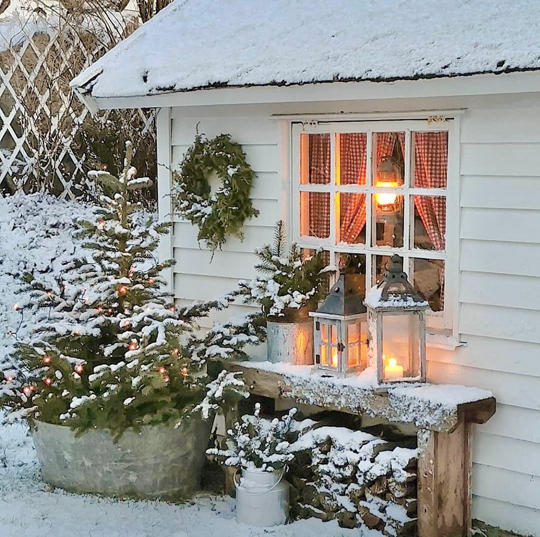 Charming Swedish holiday decor outside a rustic white cottage, @vakre_verden. #scandichristmas #swedishcottages #scandiholidaydecor